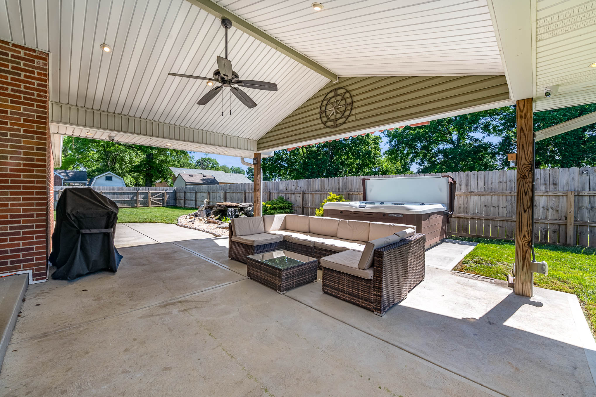 Covered patio with outdoor TV and grill